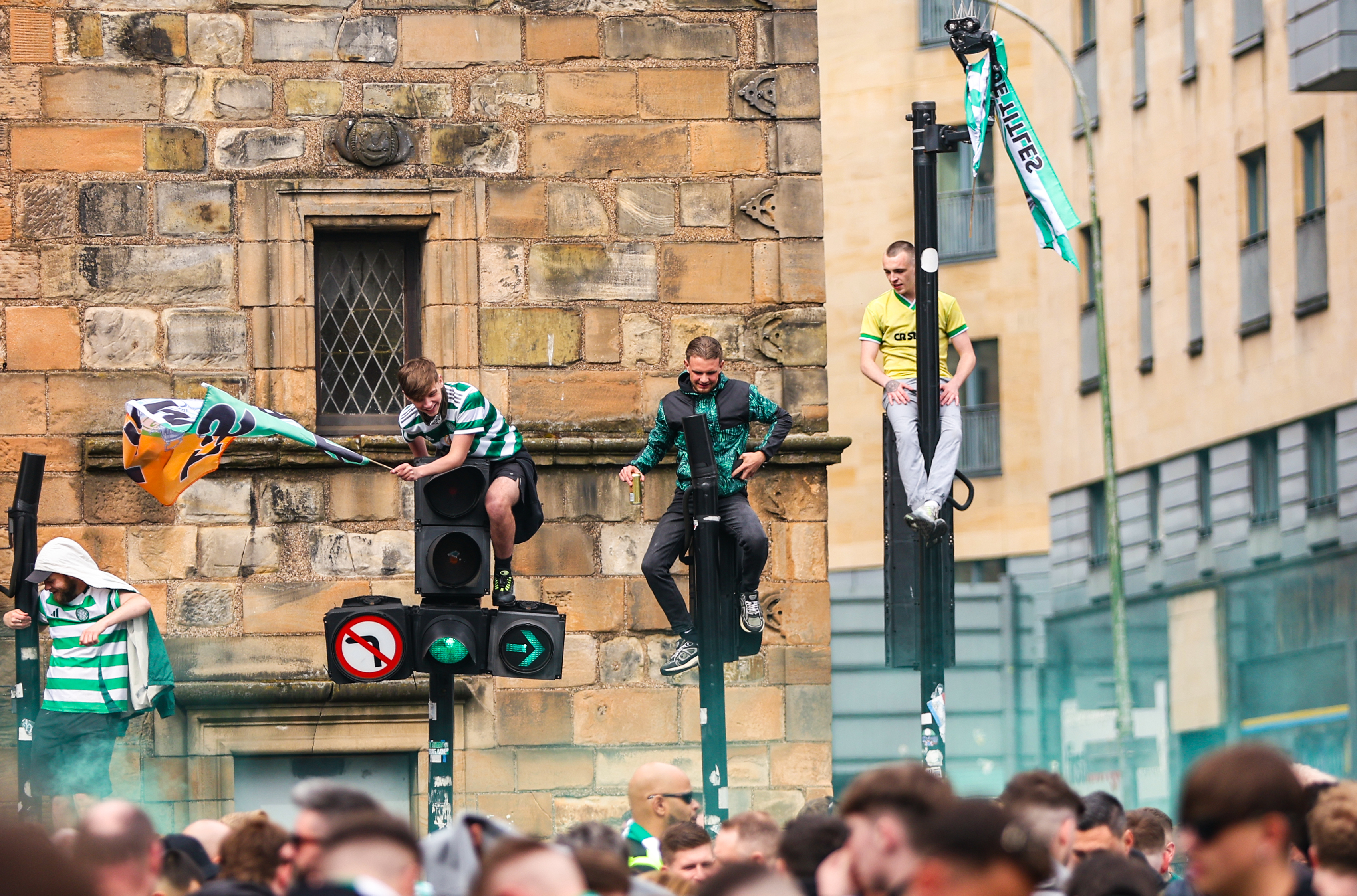 Celtic fans scaled lampposts and traffic lights at the Trongate.