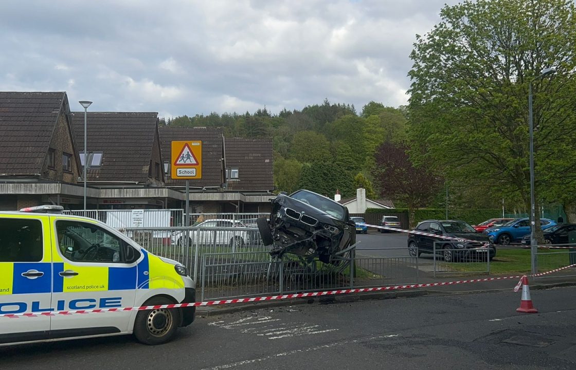 Car mounts railings after smashing into two vehicles near shop in Wemyss Bay