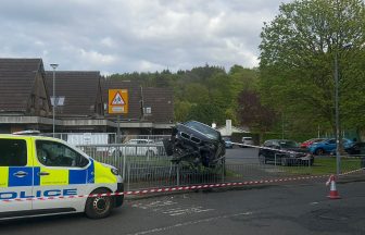 Car mounts railings after smashing into two vehicles near shop in Wemyss Bay