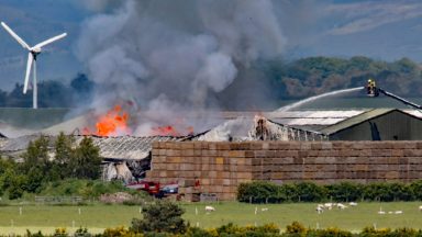 Firefighters battling blaze at farm building near Highland airfield