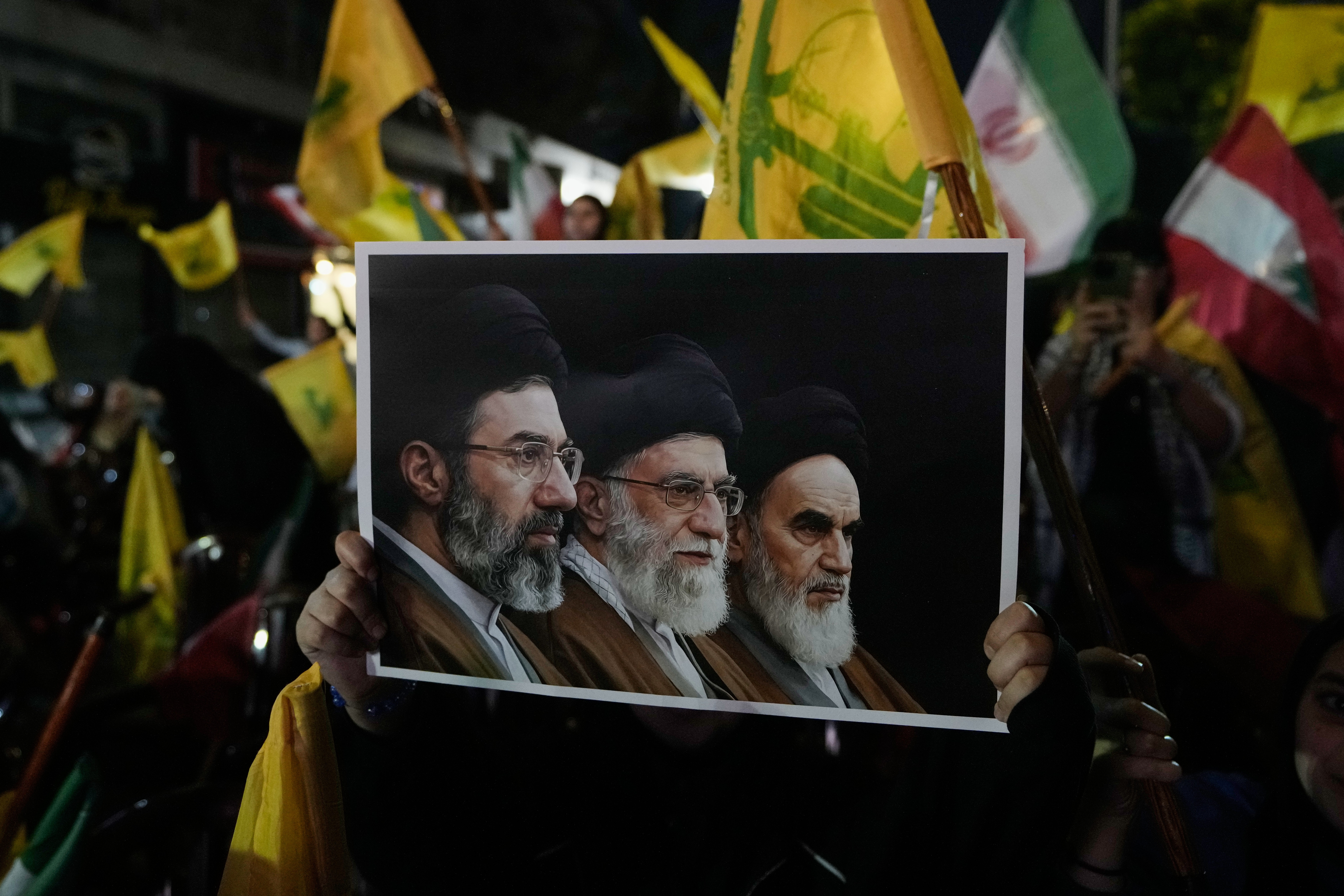 Iranian revolutionary founder Ayatollah Ruhollah Khomeini, right, the late Iranian leader Ayatollah Ali Khamenei, center, and Iranian Supreme Leader Ayatollah Mojtaba Khamenei