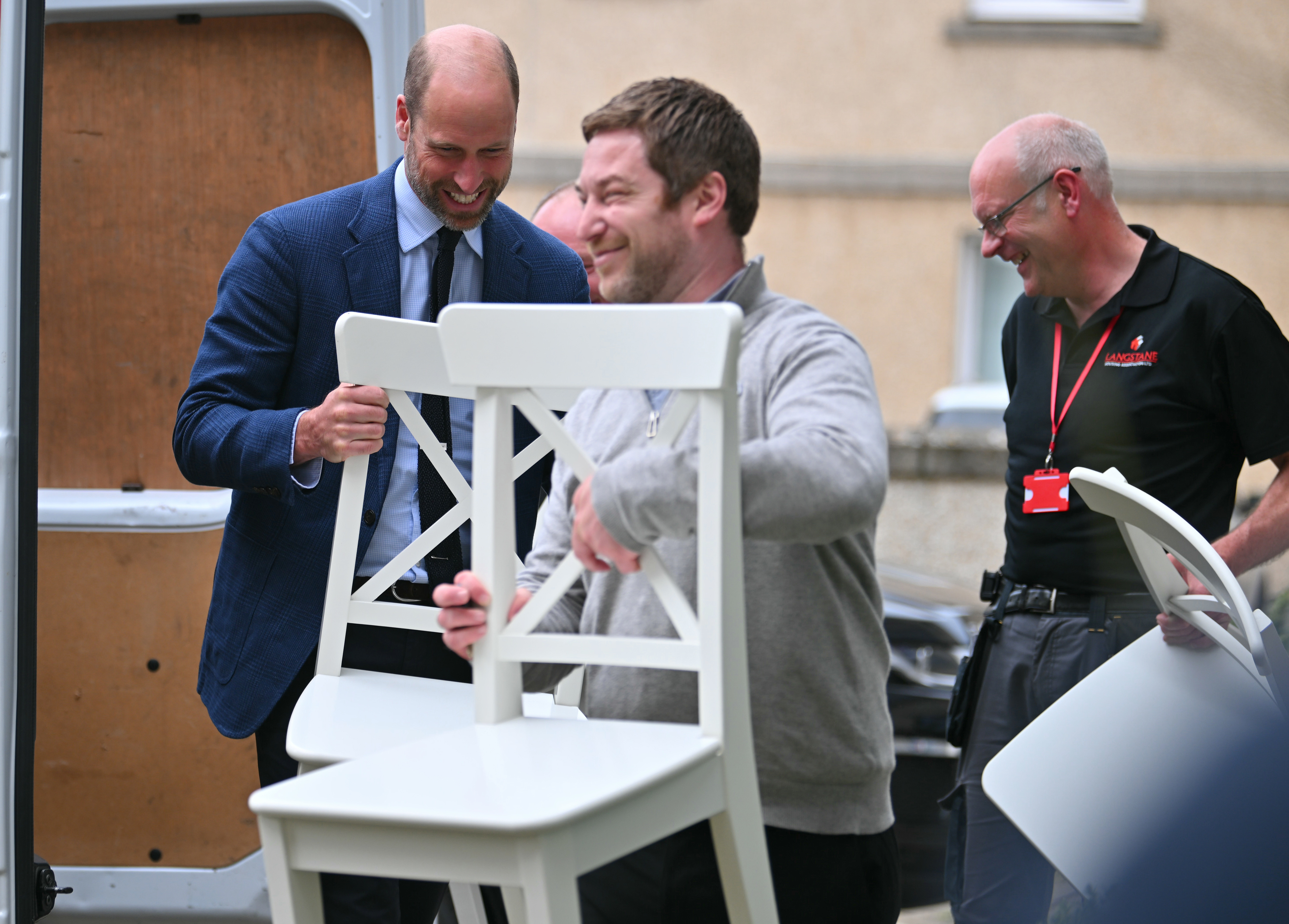 The Prince of Wales helps a new tenant move furniture into a new flat during a visit to Langstane Housing Association in Aberdeen, Scotland. Picture date: Tuesday June 30, 2026.