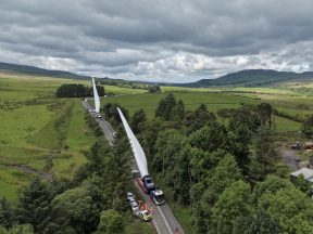 Convoy carrying massive turbine blades travels through Scotland to wind farm
