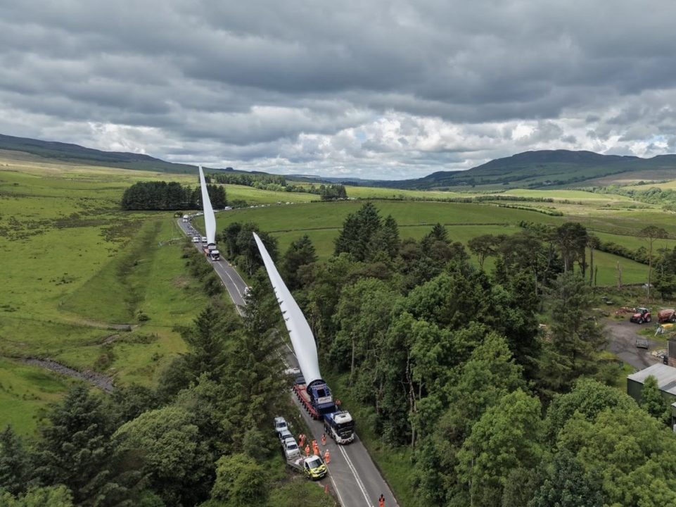 Convoy carrying massive turbine blades travels through Scotland to wind farm