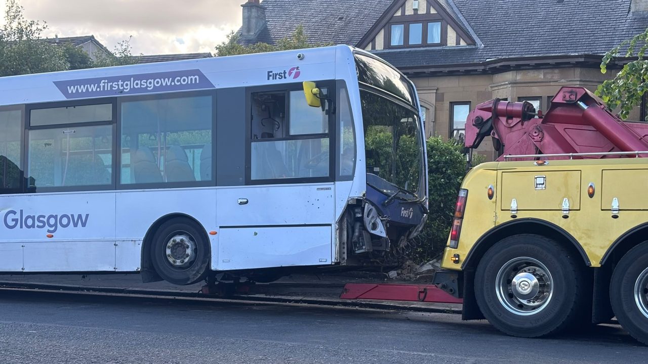 Clydebank road closed after First bus crashes into garden during early hours