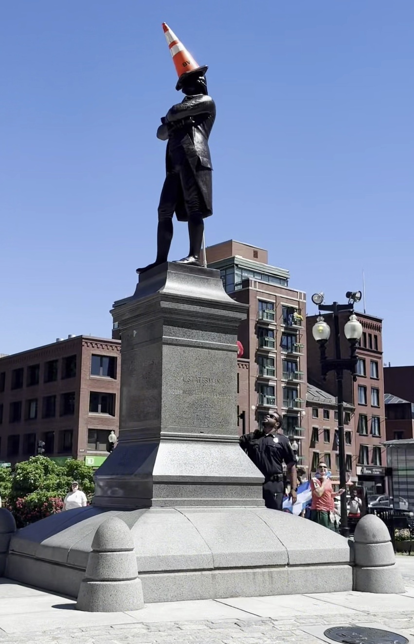 Statue in Boston with a traffic cone on its head