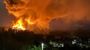 Huge blaze rips through derelict building as residents urged to keep windows shut