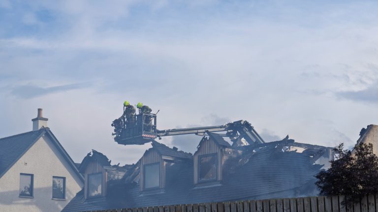 Firefighters worked to extinguish a fire affecting the roof