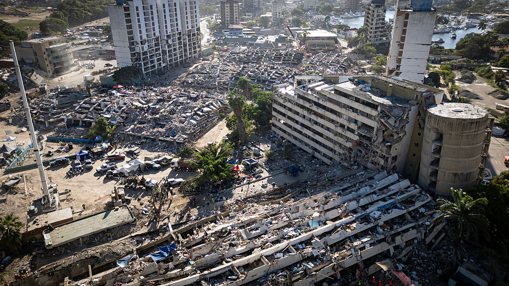 This aerial view shows heavily damaged residential buildings and widespread debris in Caraballeda, La Guaira state, Venezuela
