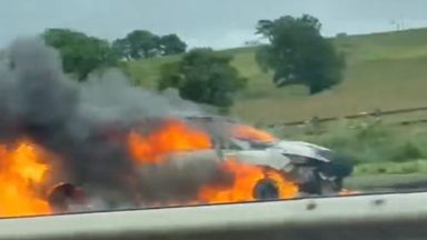 Firefighters tackle blaze as car engulfed in flames on M8