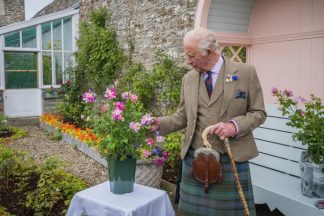 King plants royal rose as he begins summer break in Scotland