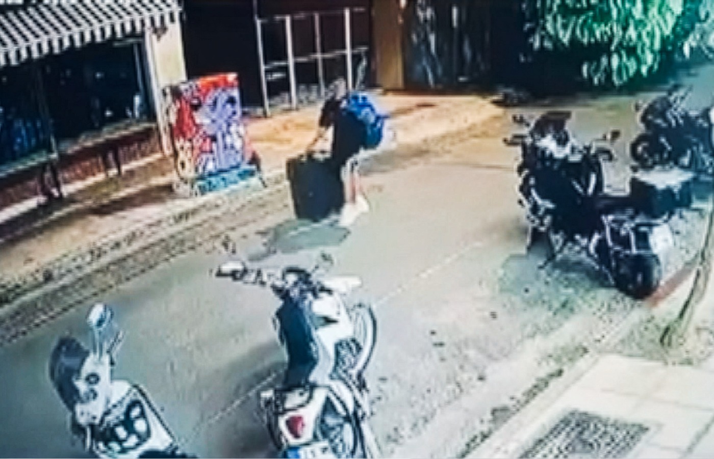 CCTV footage appears to show a man carrying a suitcase with a murdered Scottish woman inside.
