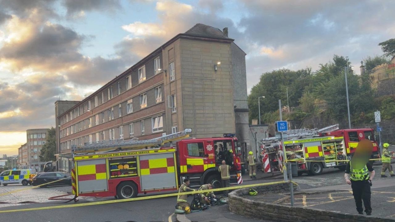 Woman taken to hospital as firefighters battle blaze at block of flats in Greenock