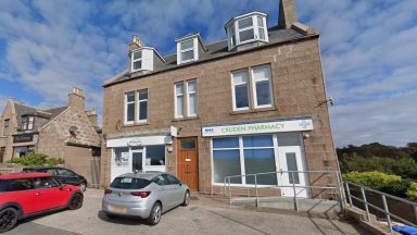 Person in hospital after car crashes through pharmacy window in Cruden Bay, Aberdeenshire