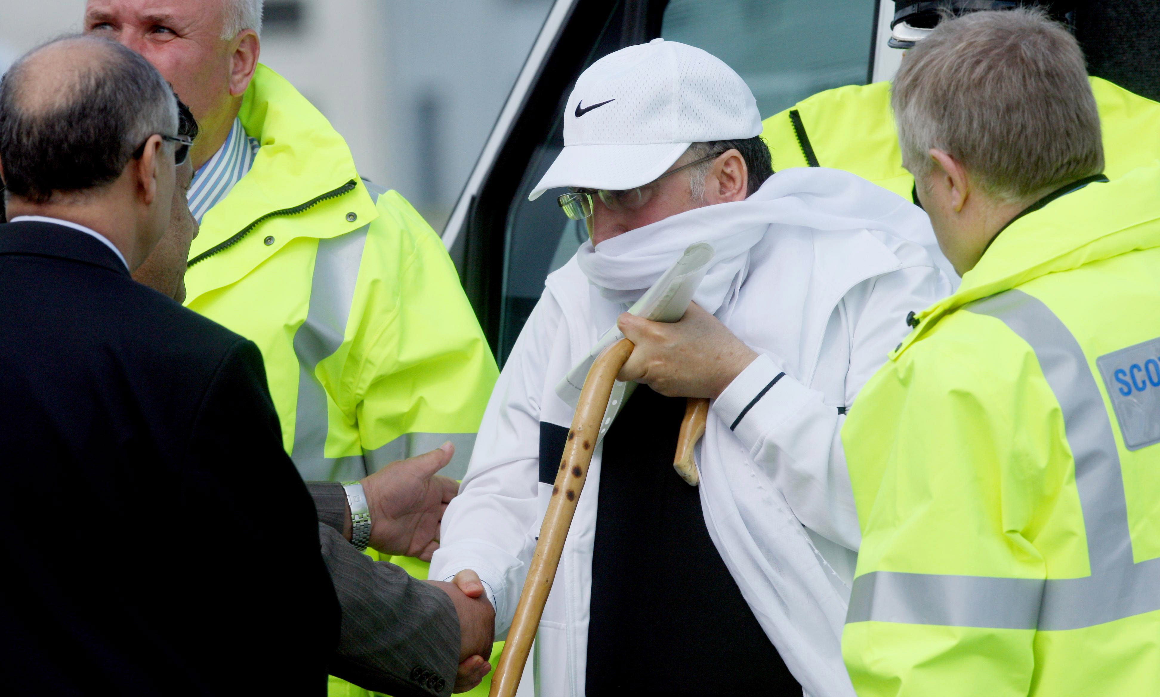 Abdelbaset Ali al-Megrahi arrives at Glasgow Airport to board a plane after arriving from Greenock Prison on August 20, 2009