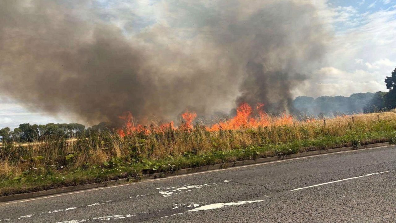 Farm machinery catches fire and spreads into field near Perth as crews battle blaze