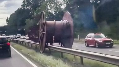Man charged after lorry spills giant cable reels onto A77