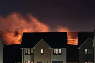 Fire crews battle fire in field near housing estate in Fife