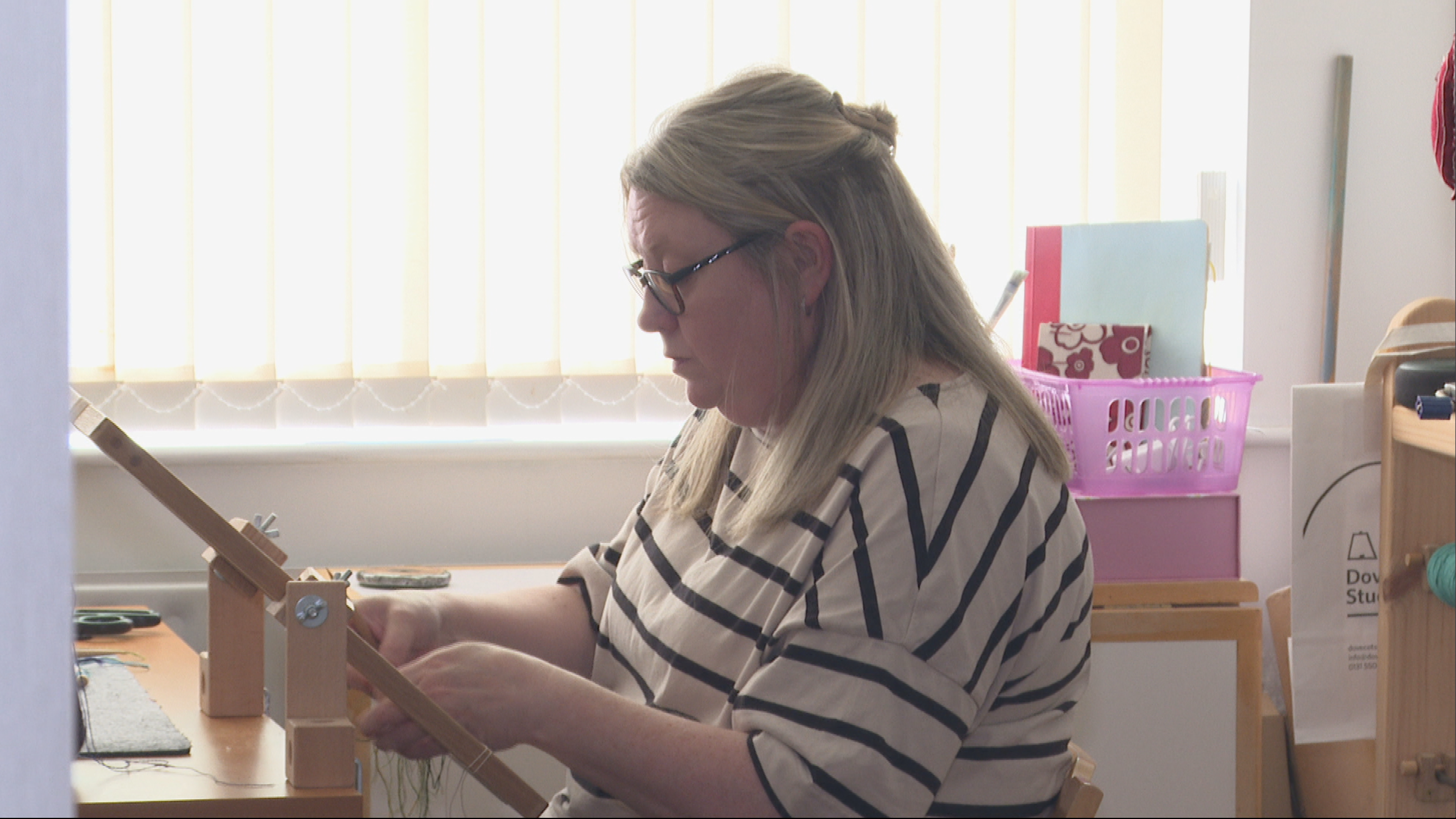 Veronica Madden weaving a tapestry at home