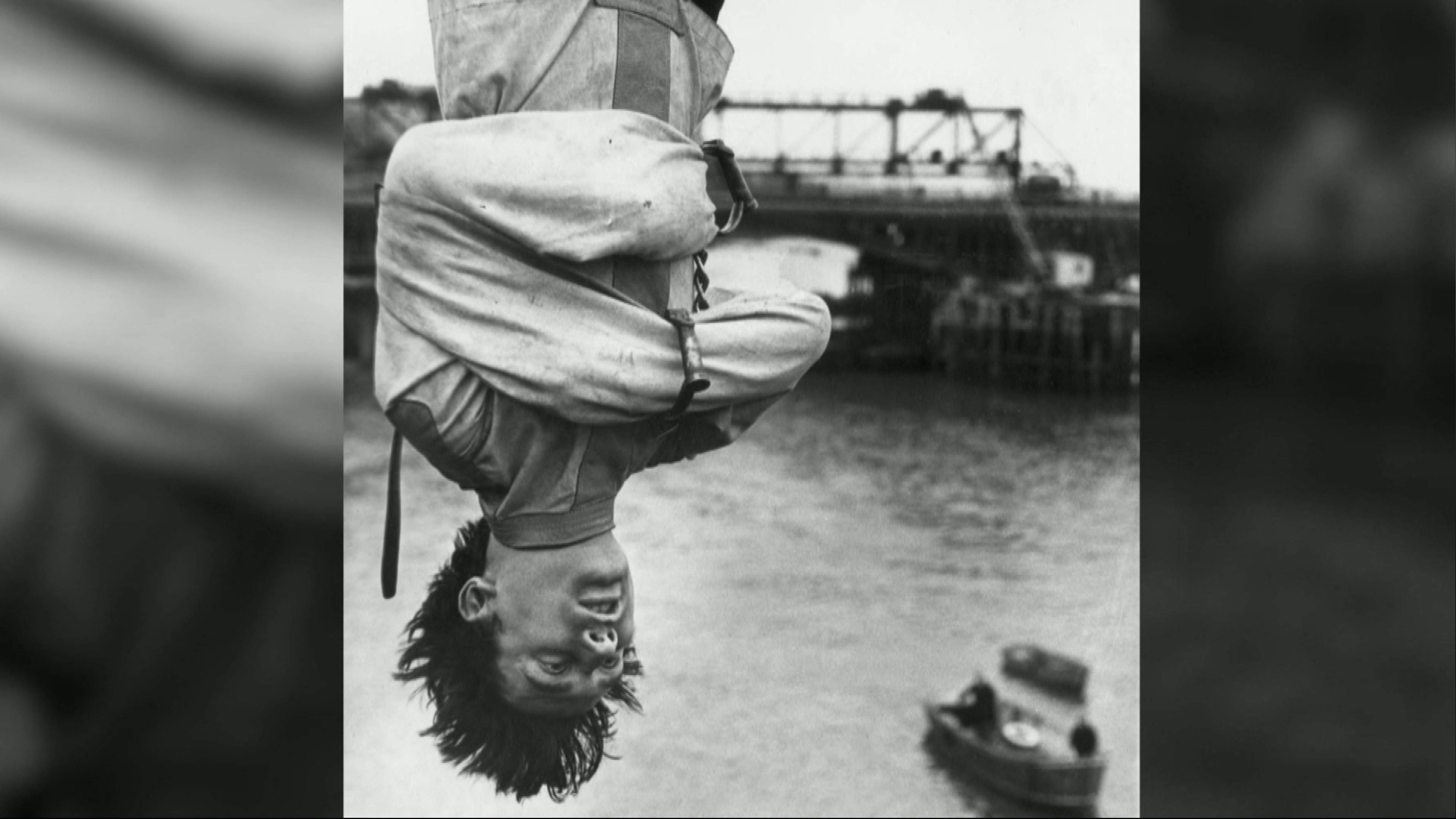 Houdini hangs upside down in famous stunt