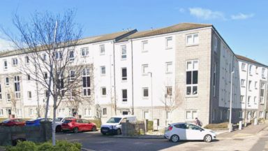 Man and woman taken to hospital after being found unresponsive at Aberdeen flat block