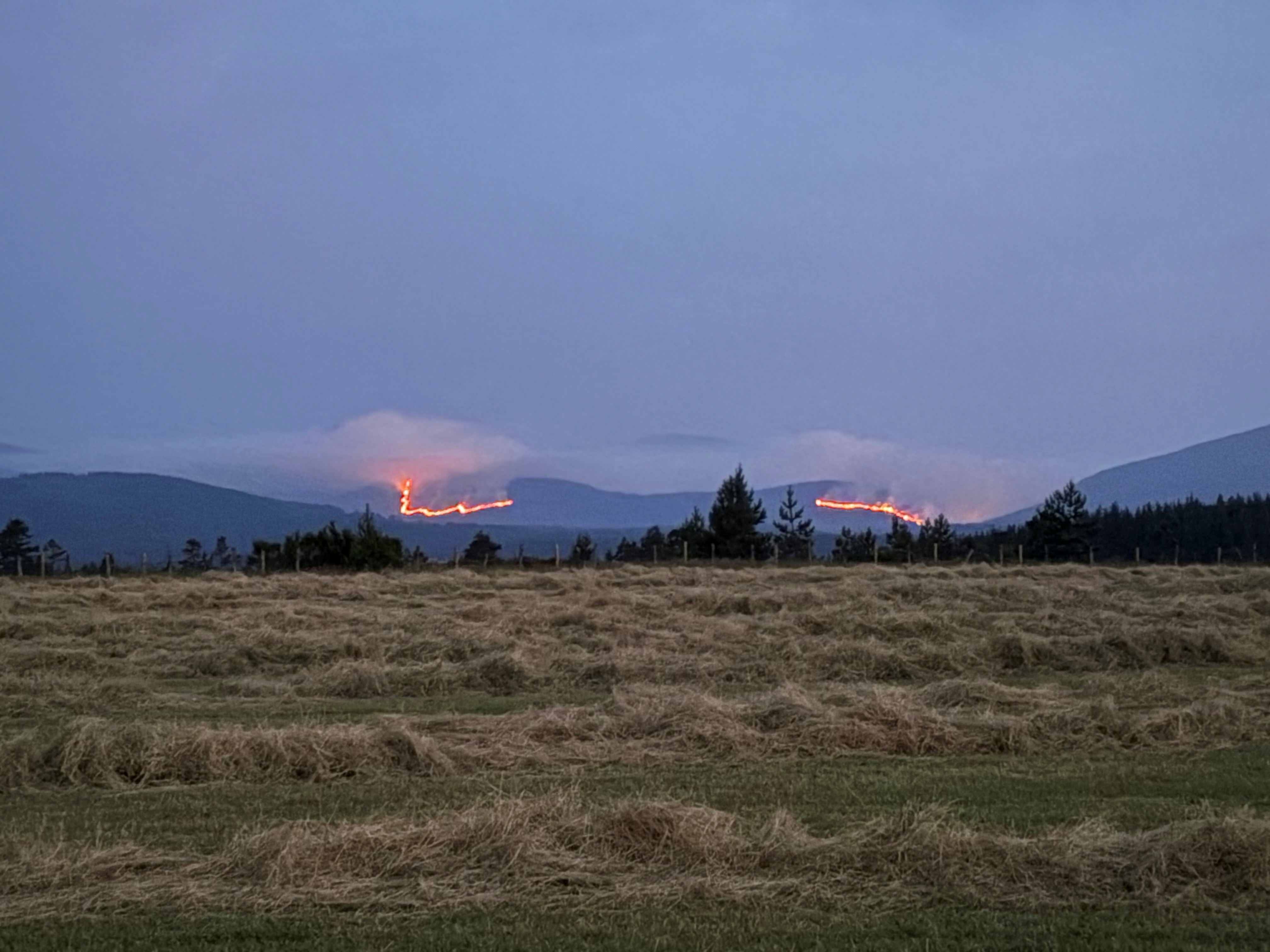 Flames and smoke from a wildfire in the Cairngorms National Park in the Scottish Highlands. Firefighters are spending a third day tackling the major wildfire which started in heathland at Ryvoan Bothy, near Nethy Bridge, late on Wednesday morning and spread to cover an area of around six kilometres by Thursday afternoon. Picture date: Thursday July 16, 2026.