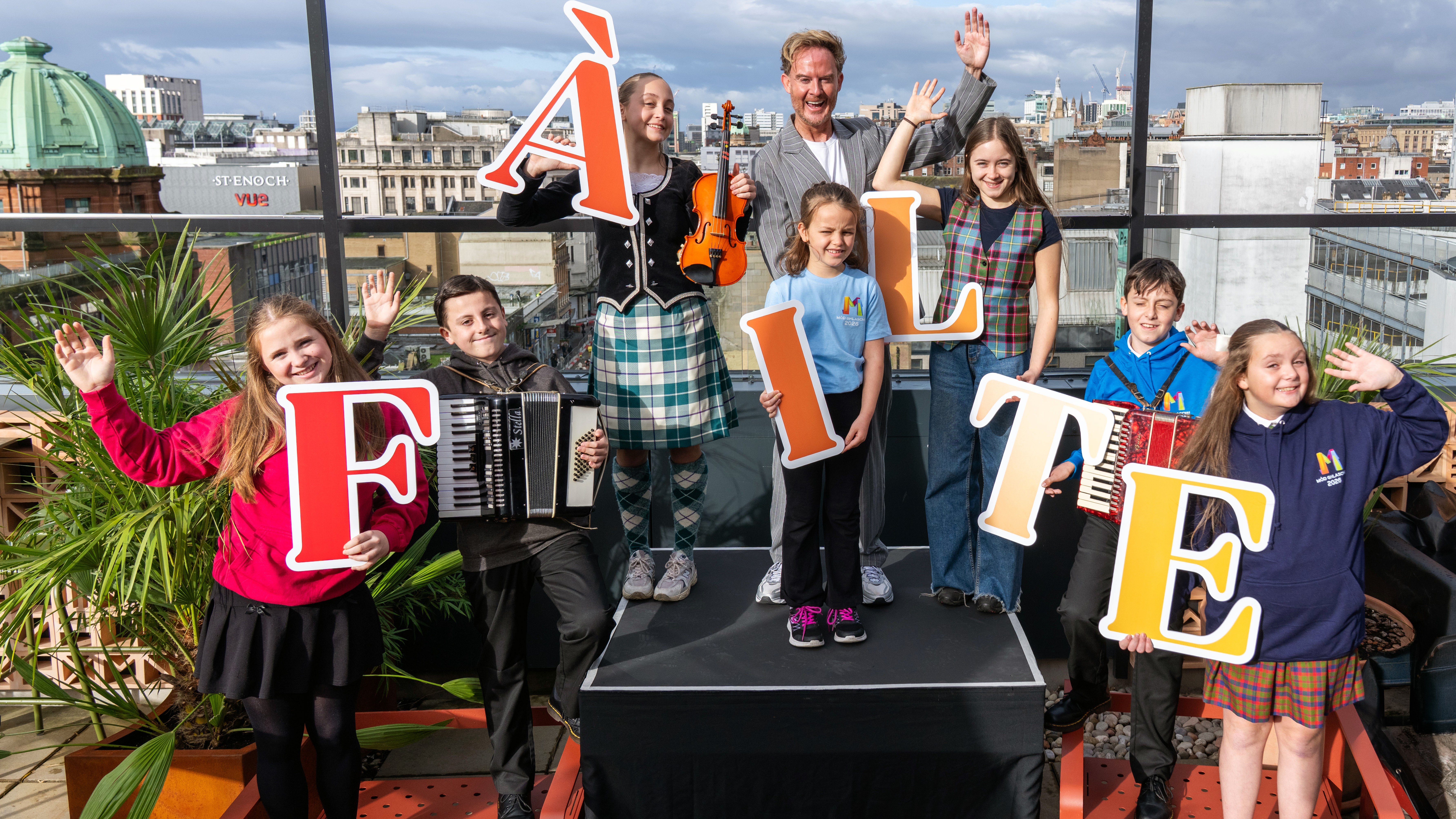 TV personality and opening concert host Phil MacHugh and young performers say ‘fàilte’, ‘welcome’, to the Royal National Mòd