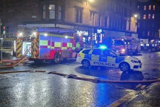 Road closed in both directions due to car fire at petrol station